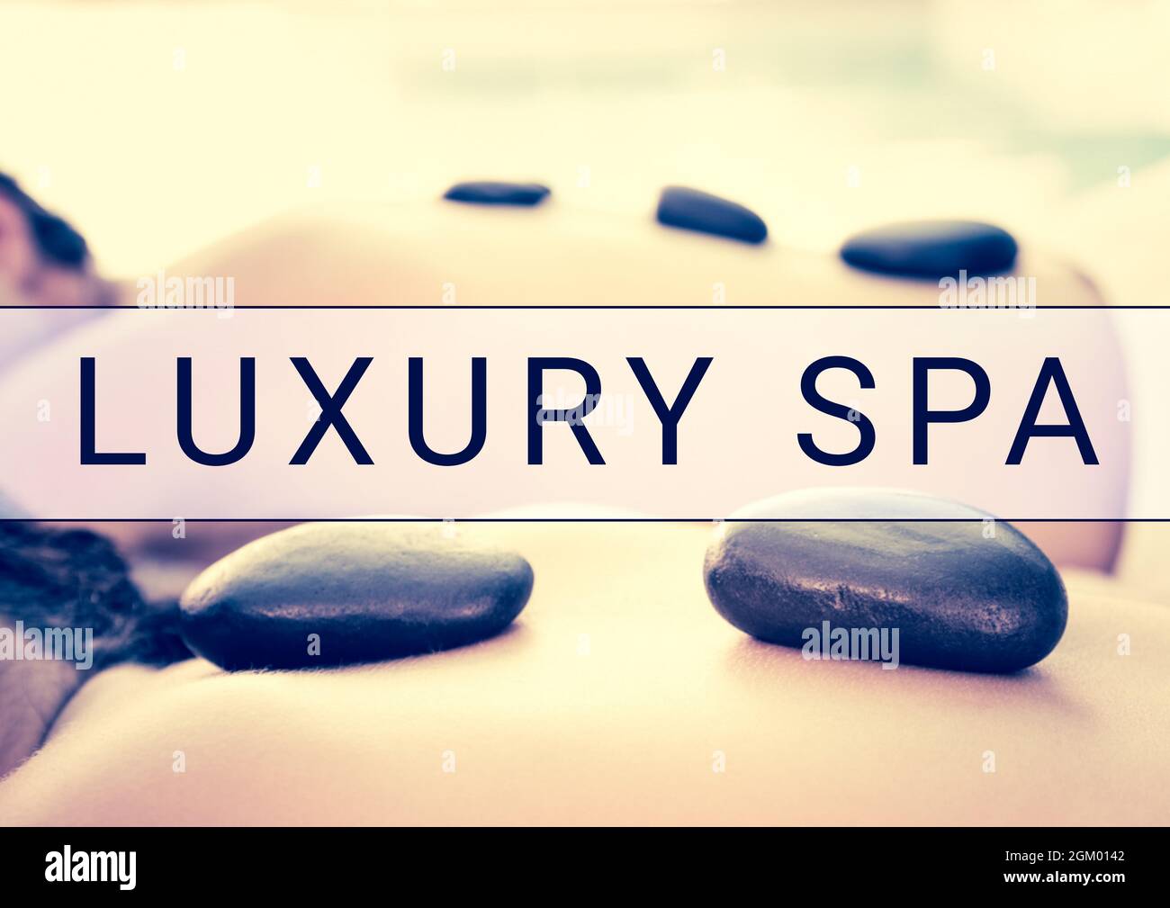 Luxury spa text banner over close up of woman lying for a massage Stock Photo