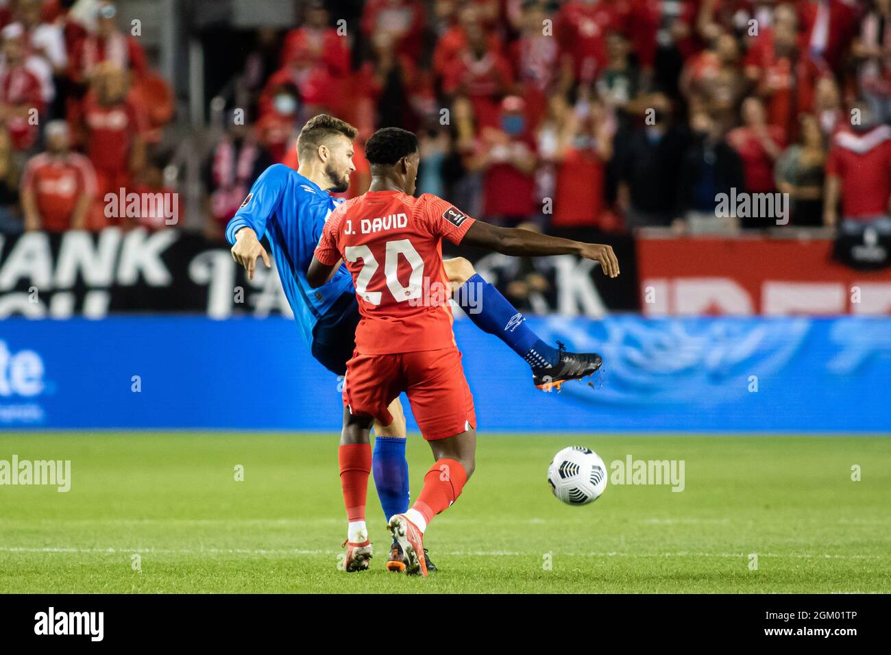 Toronto, Canada, September 8, 2021: Jonathan David (No.20/red) of Team  Canada in action against Eriq Zavaleta (No.4/blue) of Team El Salvador  during the CONCACAF FIFA World Cup Qualifying 2022 match against El