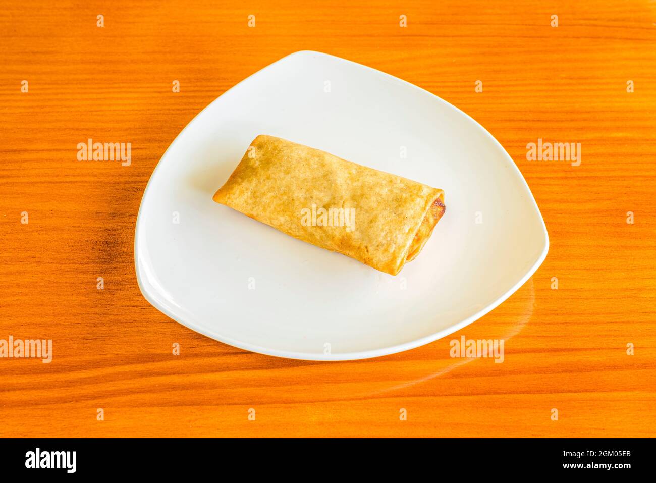 Traditional crispy spring roll stuffed with vegetables and meat cooked in a Chinese restaurant Stock Photo