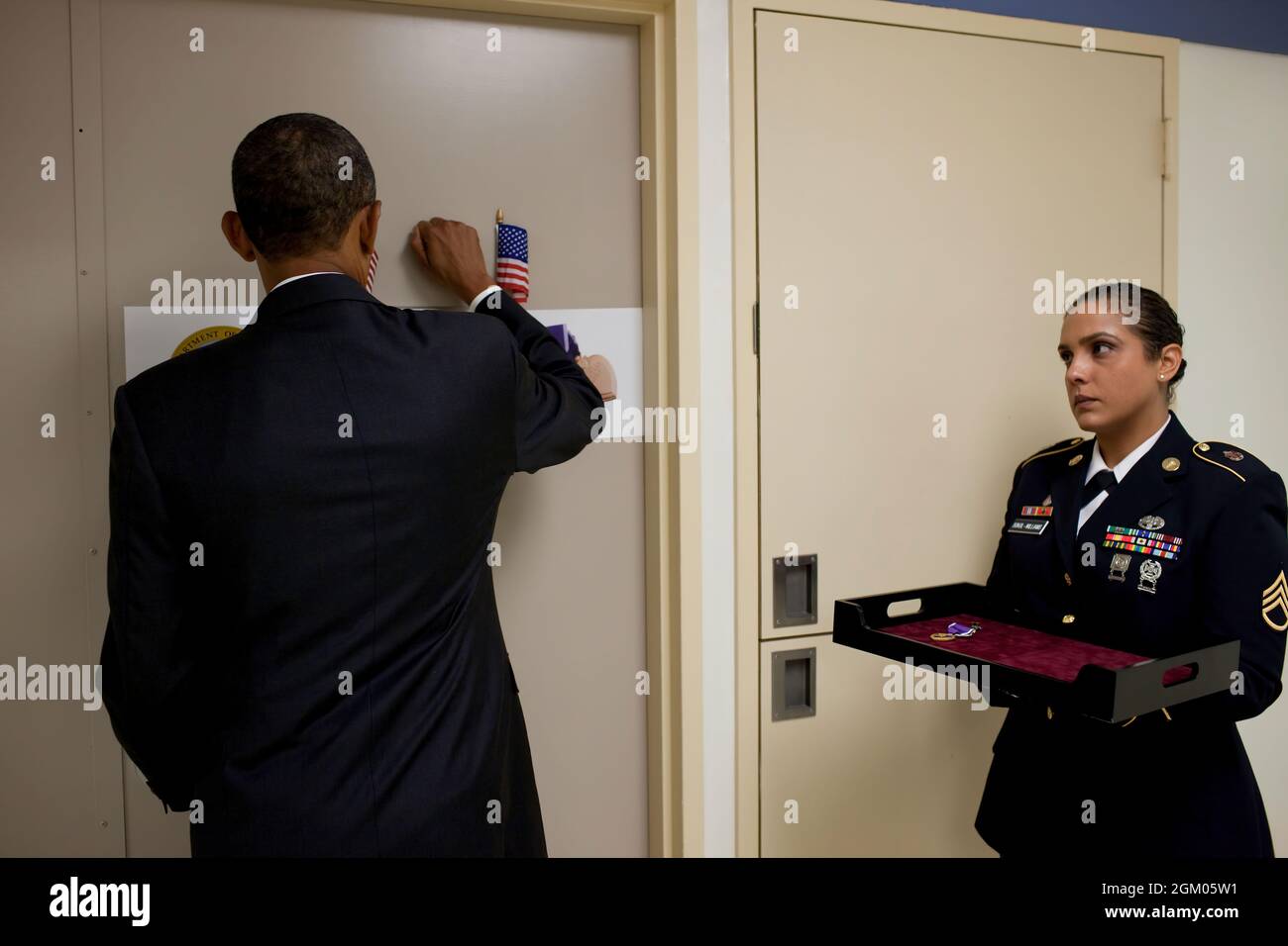 President Barack Obama knocks on the door before entering a soldier's room at Walter Reed Army Medical Center in Washington, D.C., Aug. 30, 2010. The President met with 24 wounded warriors who served in Afghanistan, five who served in Iraq, and honored 11 soldiers with the Purple Heart. (Official White House Photo by Pete Souza) This official White House photograph is being made available only for publication by news organizations and/or for personal use printing by the subject(s) of the photograph. The photograph may not be manipulated in any way and may not be used in commercial or political Stock Photo