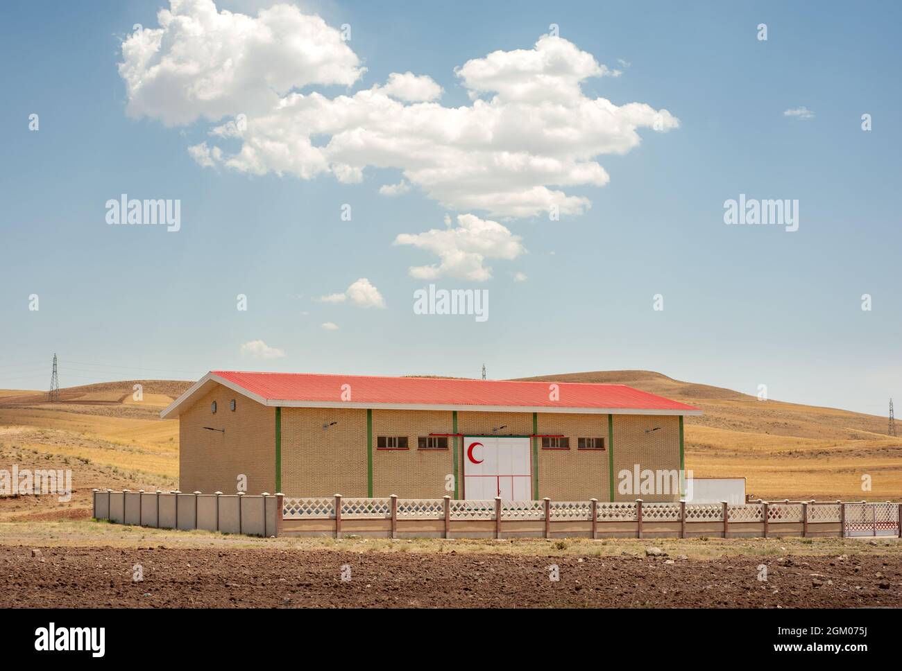 a Red Crescent Society building or hanger in iran with partly cloudy sky, kurdistan province Stock Photo