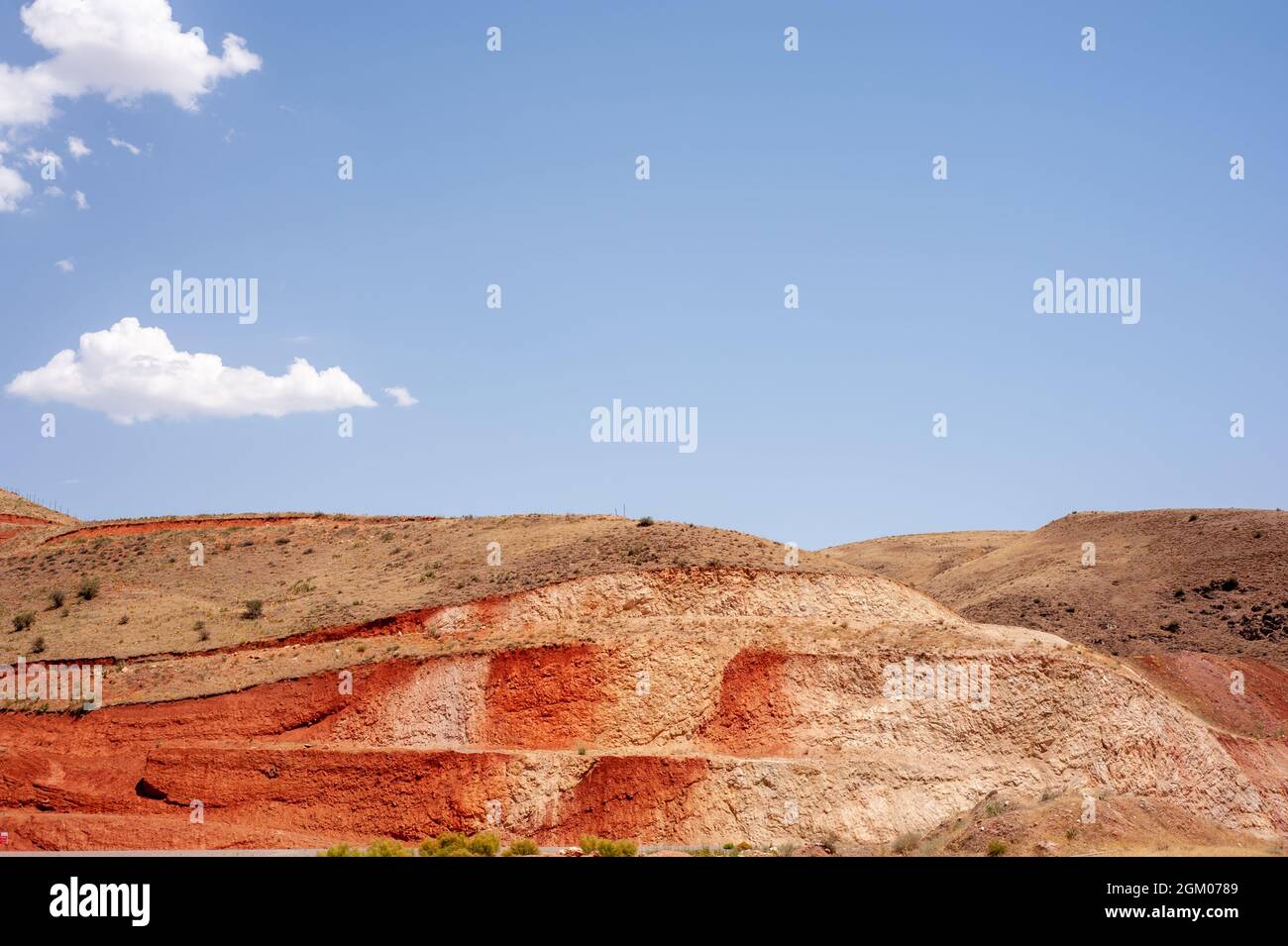Sideling Hill, syncline, metamorphic layers, Allegheny Mountains, Appalachian Mountains for road construction in iran with blue cloudy sky Stock Photo