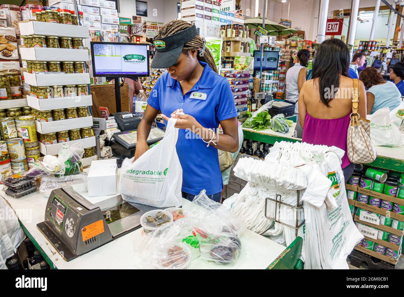Delray Beach Florida,The Boys Farmers Market,gourmet grocery store supermarket food Black teen teenager girl plastic bag,checkout bagger bagging cashi Stock Photo