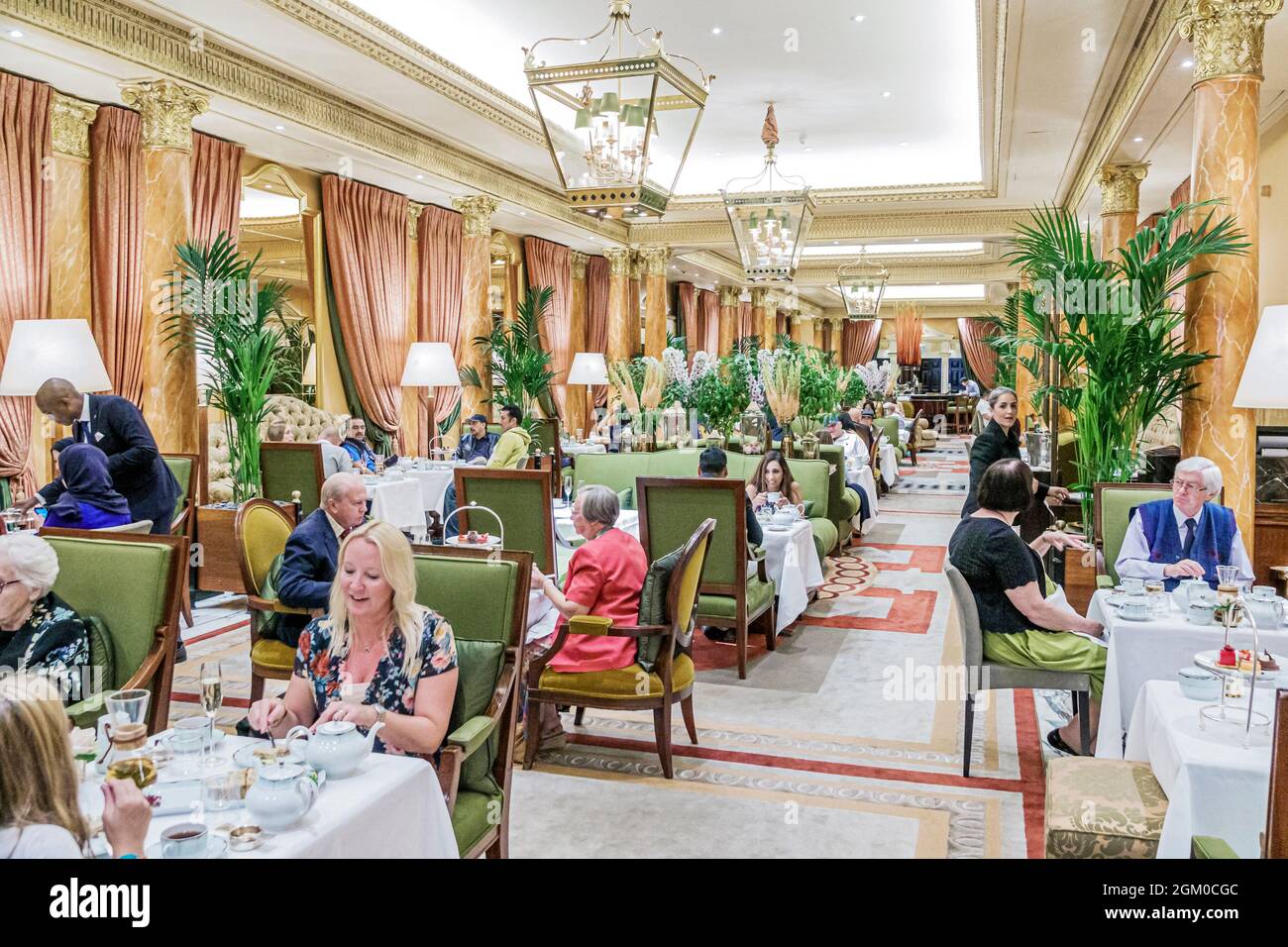 London England,UK,West End City Westminster Mayfair,Park Lane,The Dorchester hotel,luxury 5-star The Promenade restaurant dining afternoon tea tables Stock Photo