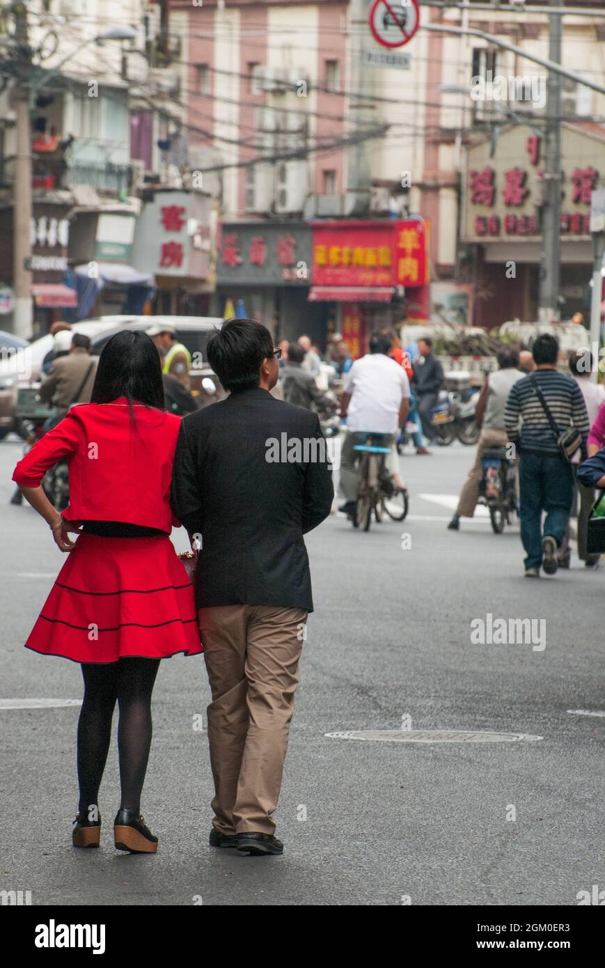 Chinese couple strolling through the Zhapu Lu Food Street area