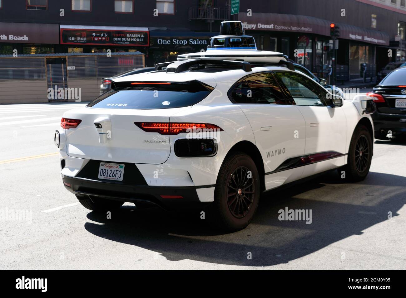 Waymo Jaguar I-Pace self driving car performing tests on urban street. Read side view - San Francisco, California, USA - 2021 Stock Photo