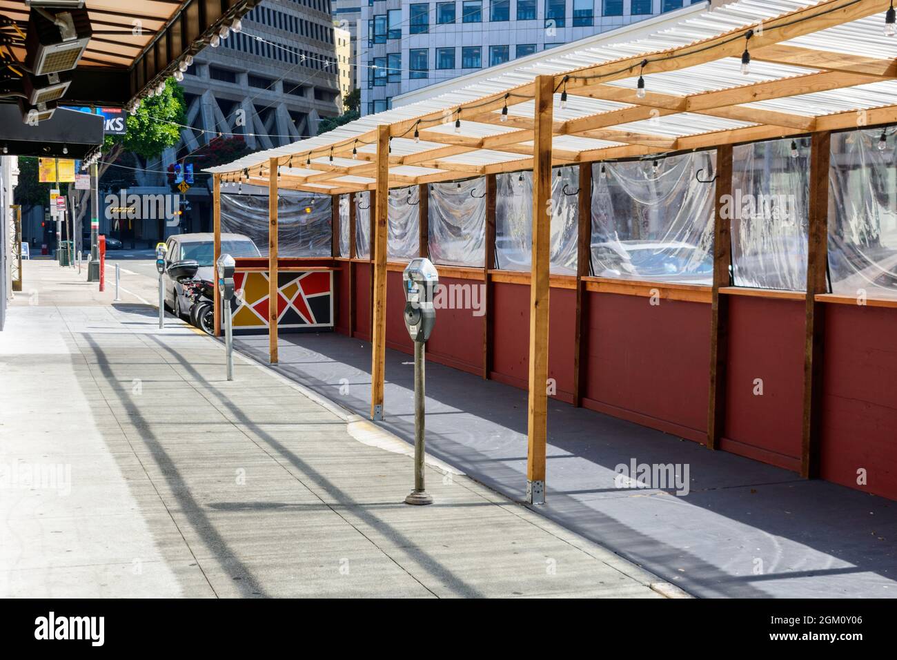 An empty parklet space installed on parking lanes and uses several parking spaces on the Columbus avenue - San Francisco, California, USA - 2021 Stock Photo