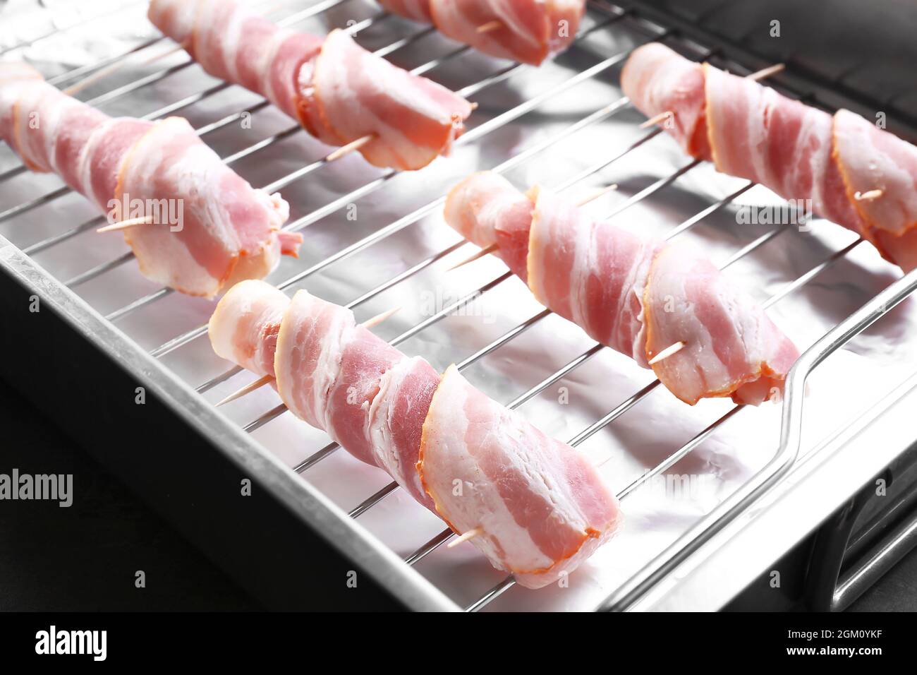 Bacon wrapped chicken nuggets on baking rack, closeup Stock Photo Alamy