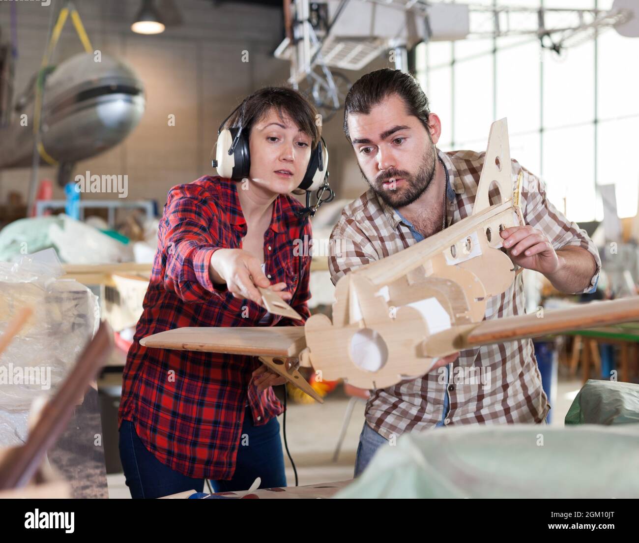 Team creating airplane models Stock Photo