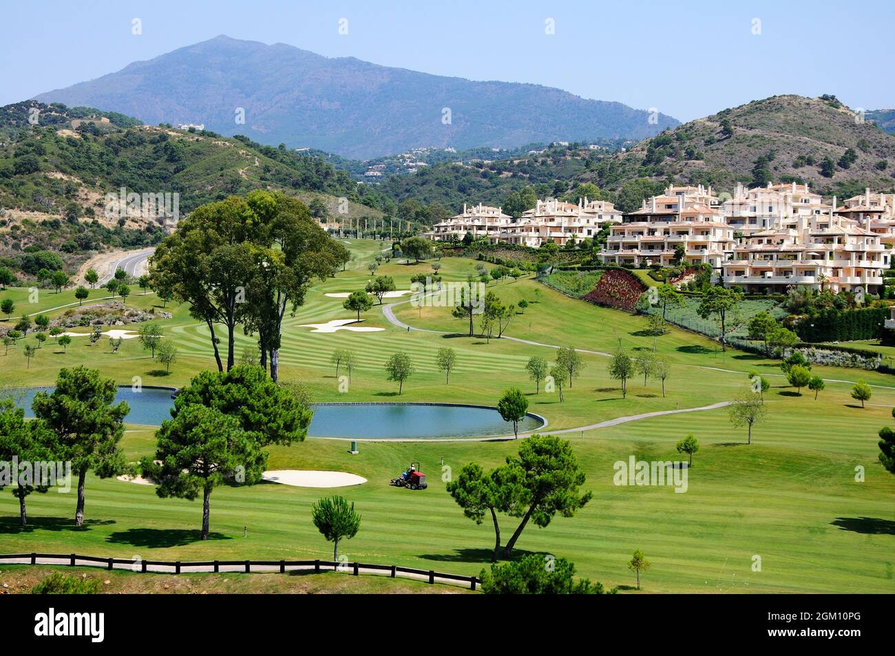 View across El Higueral Golf Course with apartments and mountains to the rear, Benahavis, Spain. Stock Photo