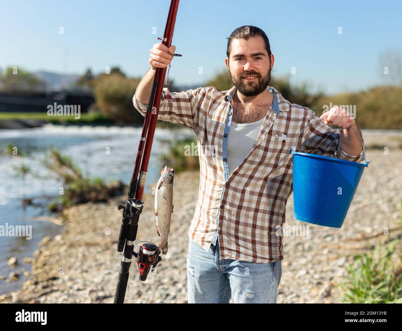 The fisherman ties the hook to the line. Tie the fishing hook to the fishing  line. Fish hook on the palm. Holding a hook Stock Photo - Alamy