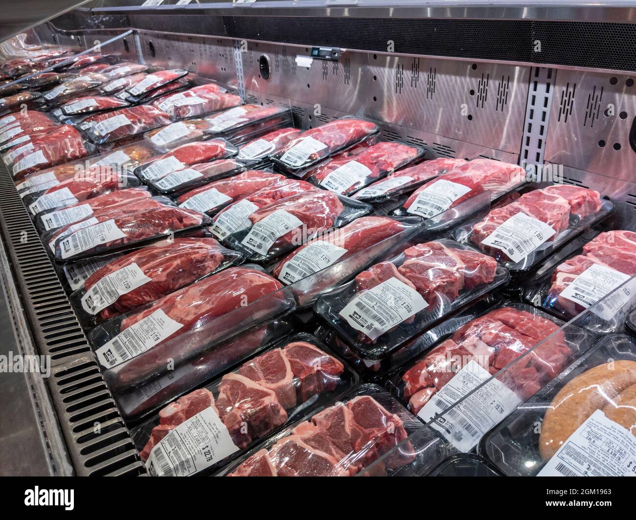 Kirkland WA USA - circa September 2021: Angled view of the refrigerated meats section inside a Whole Foods Market grocery store. Stock Photo