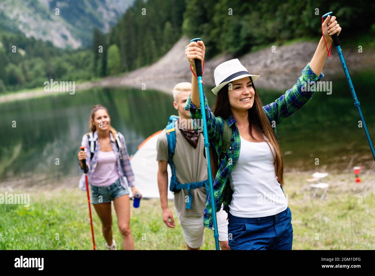 Group of young friends hiking in countryside. Multiracial happy people ...