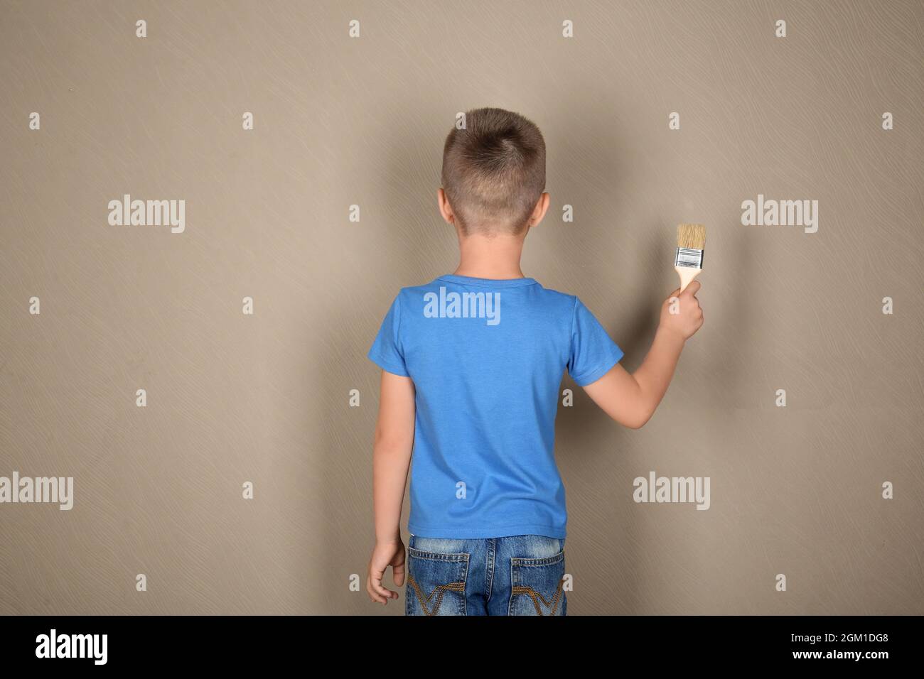 Cute little boy painting wall Stock Photo Alamy