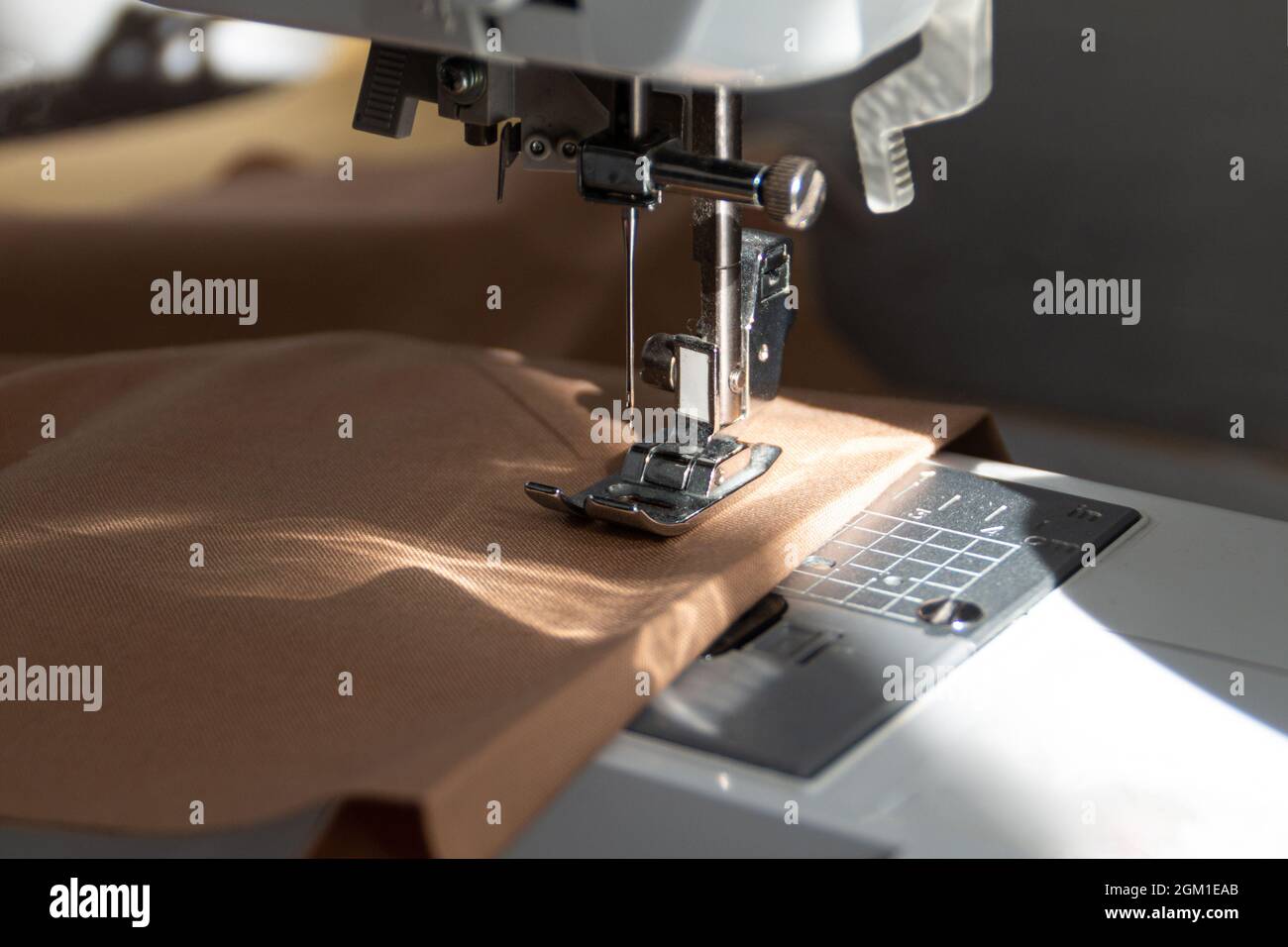 sewing machine close up view with natural sunlight, slow fashion and