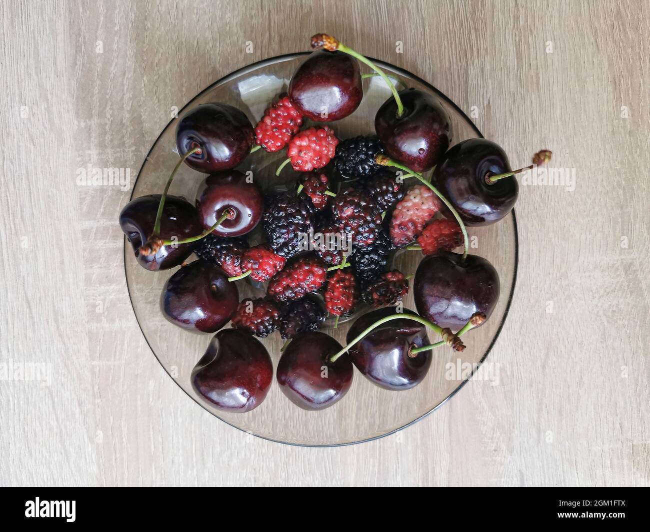 Fresh black mulberry berries and sweet cherry Stock Photo