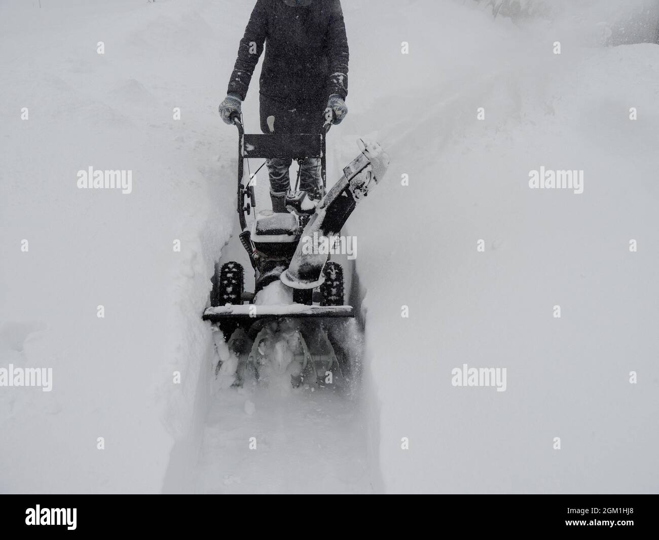 Clearing snow with a snowblower after a heavy snowfall Stock Photo Alamy