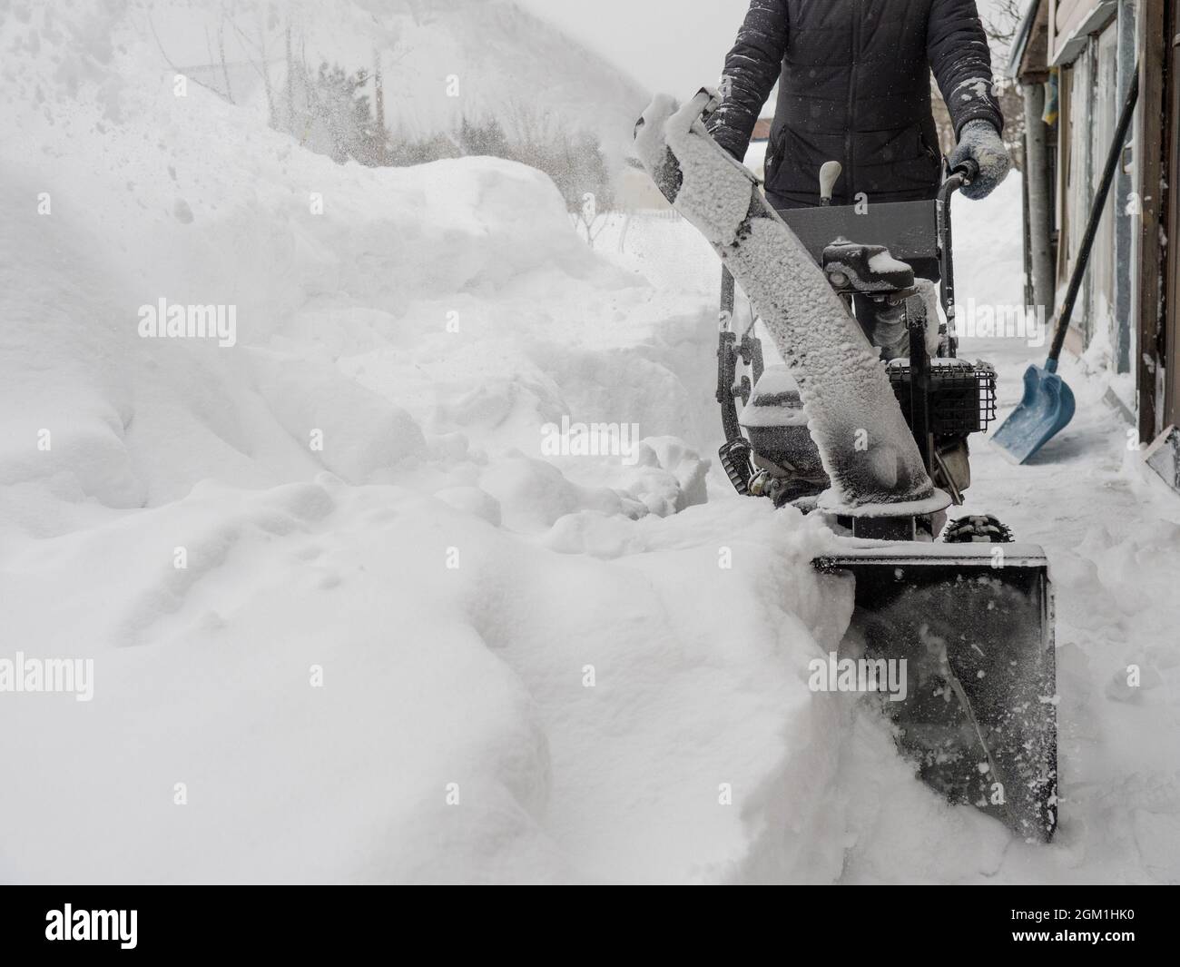 Clearing snow with a snowblower after a heavy snowfall Stock Photo Alamy