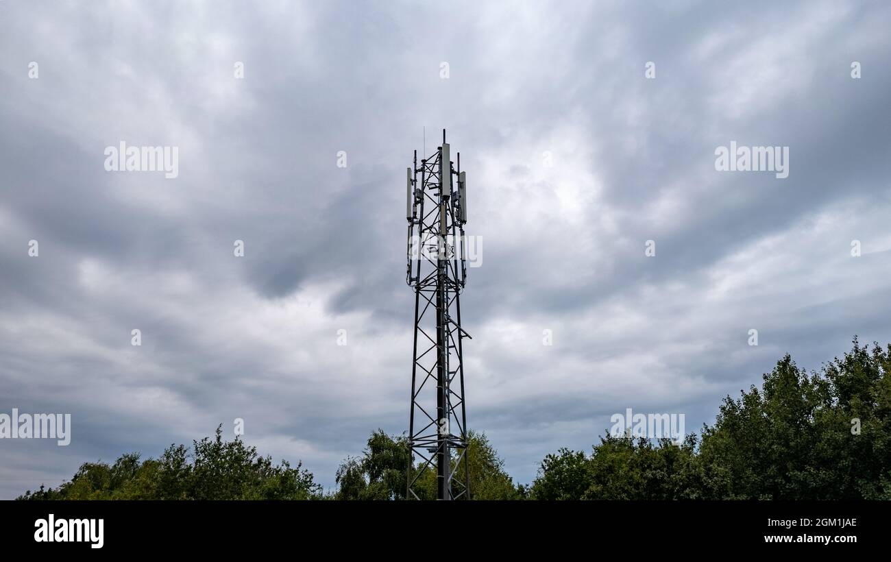 3G, 4G, 5G. Mobile phone base station Tower. Development of communication  system in npn-urban forest area with dark stormy grey sky background. High  quality photo Stock Photo - Alamy