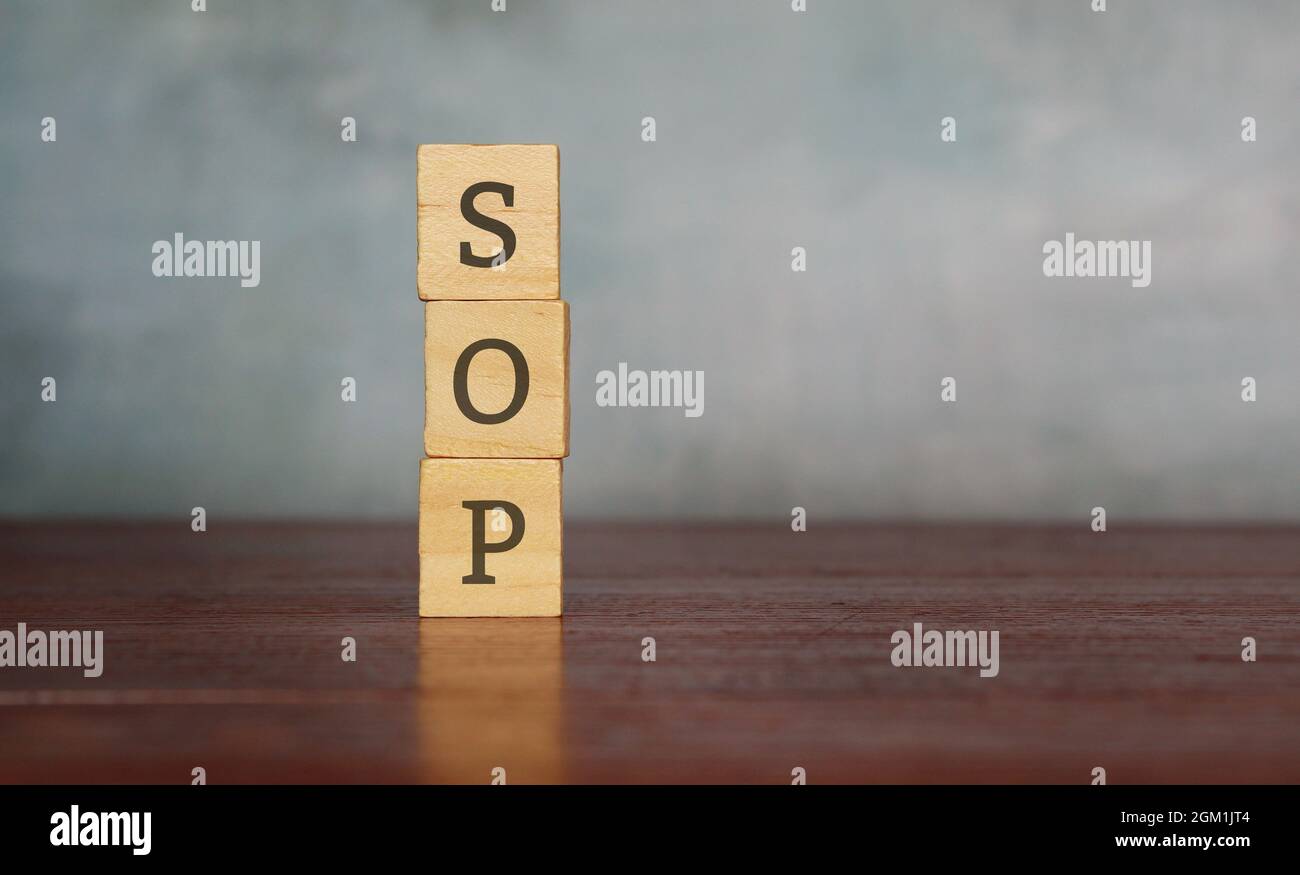 Stack wooden cube with text SOP or standard operating procedure. Copy space for text Stock Photo