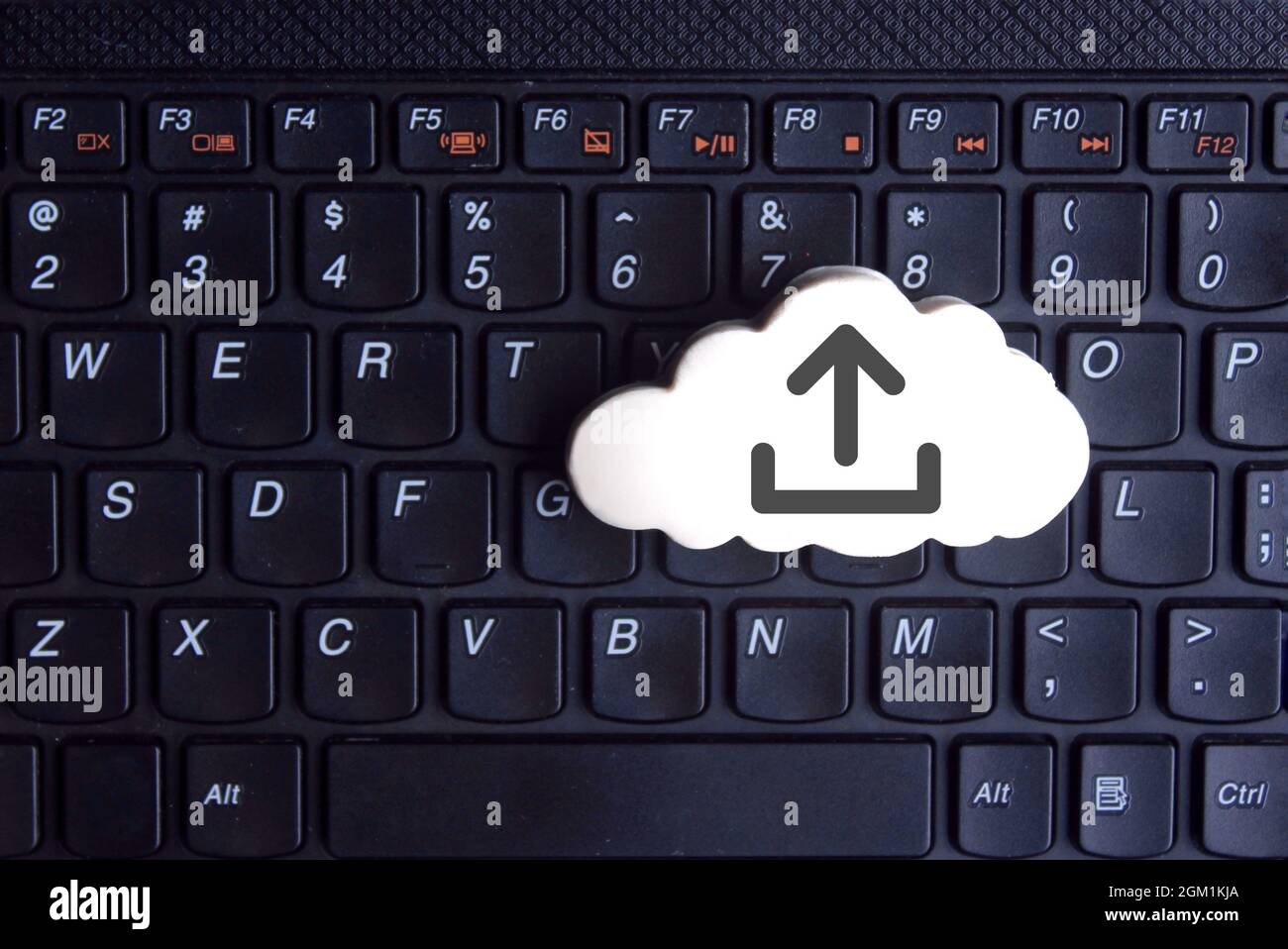 Technology, cloud computing concept. White cloud with upload icon on keyboard Stock Photo
