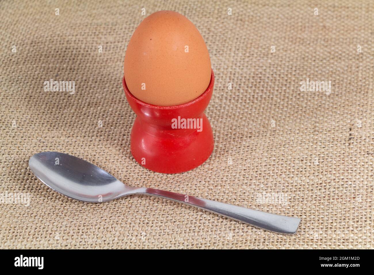 Soft-boiled egg in an eggcup and spoon Stock Photo - Alamy