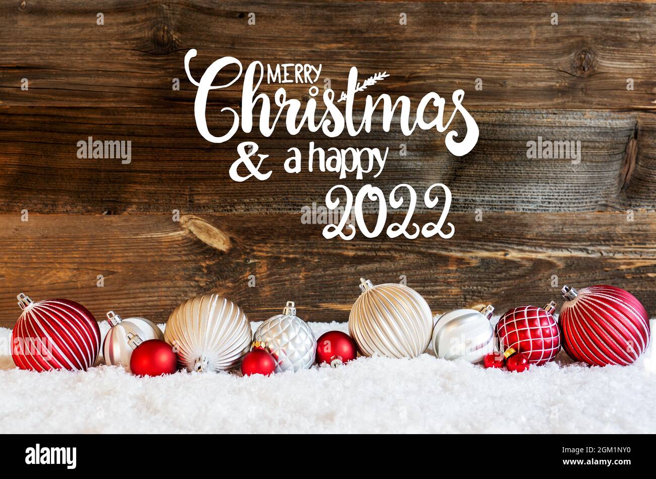 Calligraphy Merry Christmas 2022 English Calligraphy Merry Christmas And A Happy 2022 On Rustic Brown Wooden  Backgroud. Red And White Festive Christmas Ball Ornament On Snow Stock  Photo - Alamy