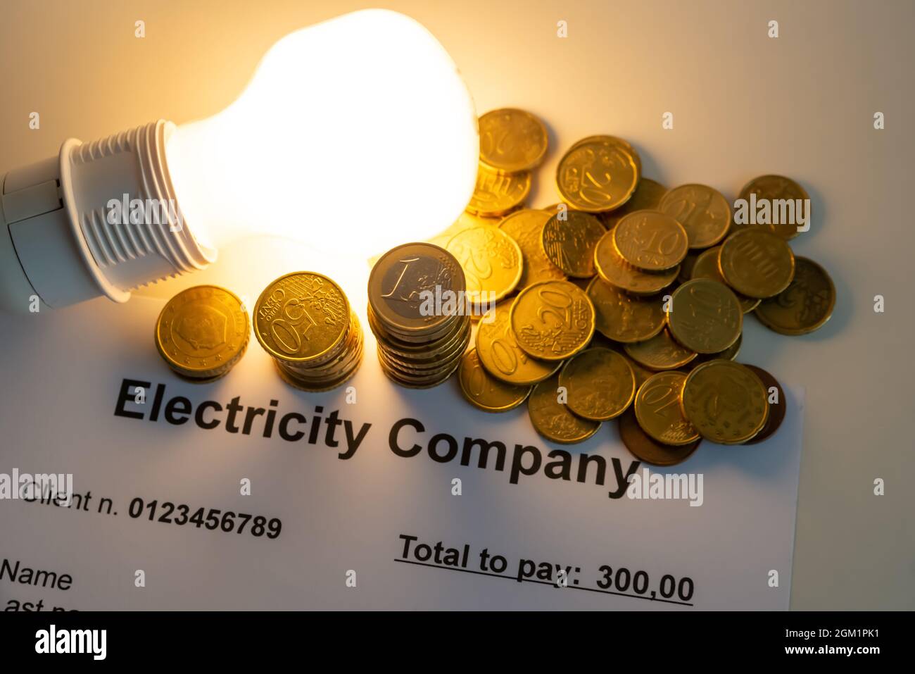 Light bulb on, with banknotes, coins and energy bill. Increase in