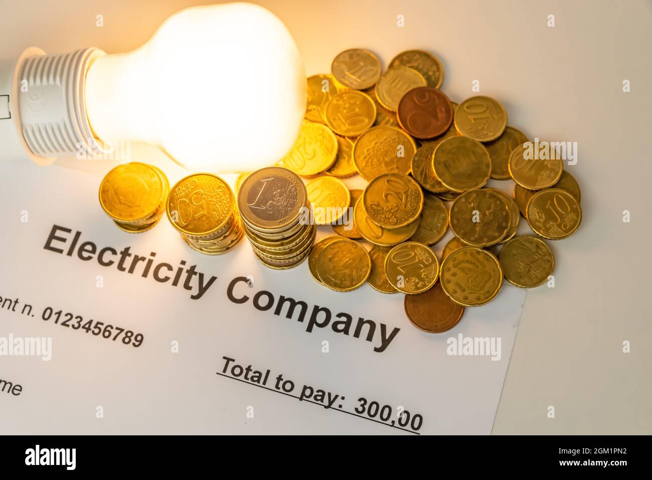 Light bulb on, with banknotes, coins and energy bill. Increase in