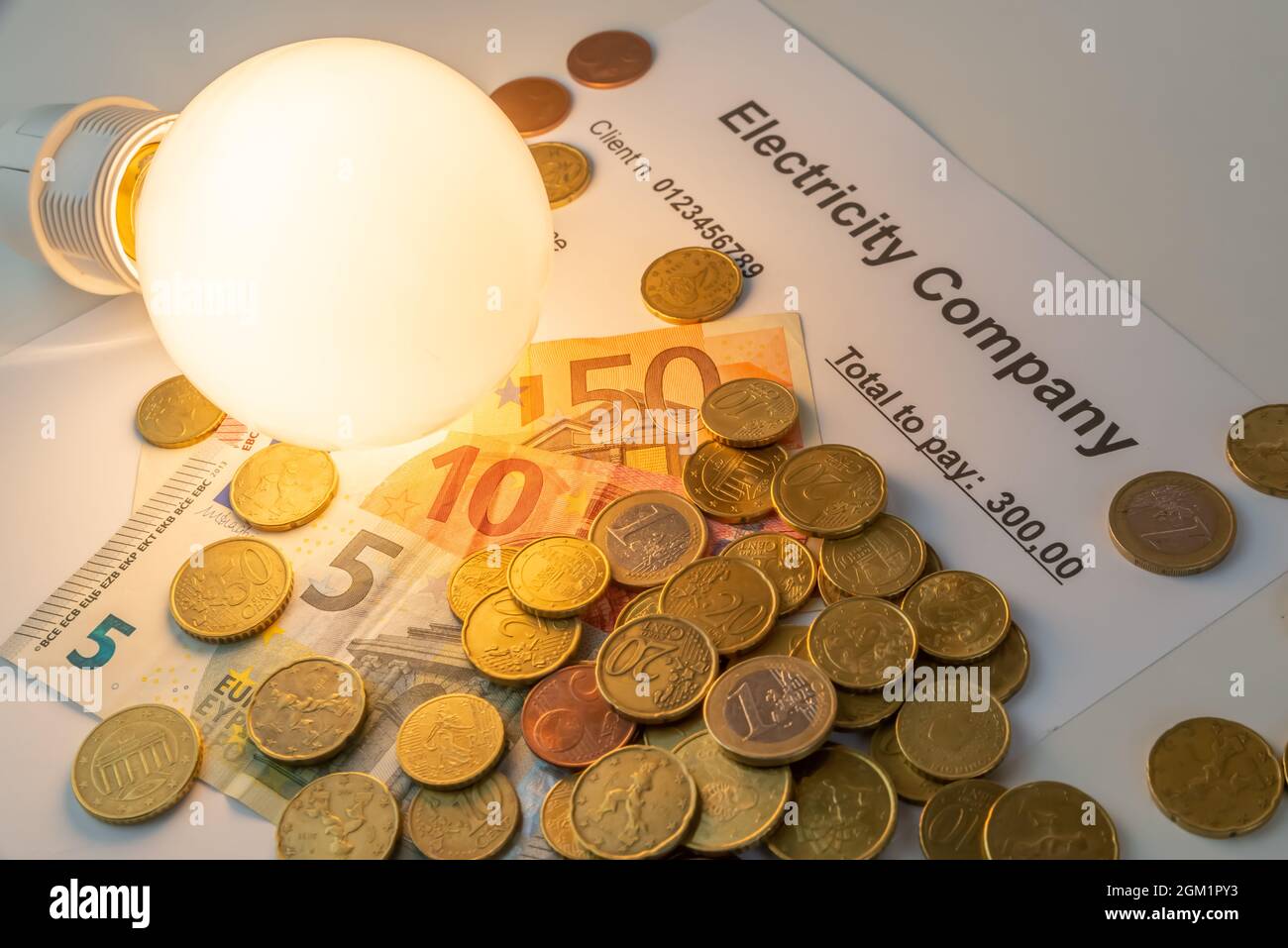 Light bulb on, with banknotes, coins and energy bill. Increase in
