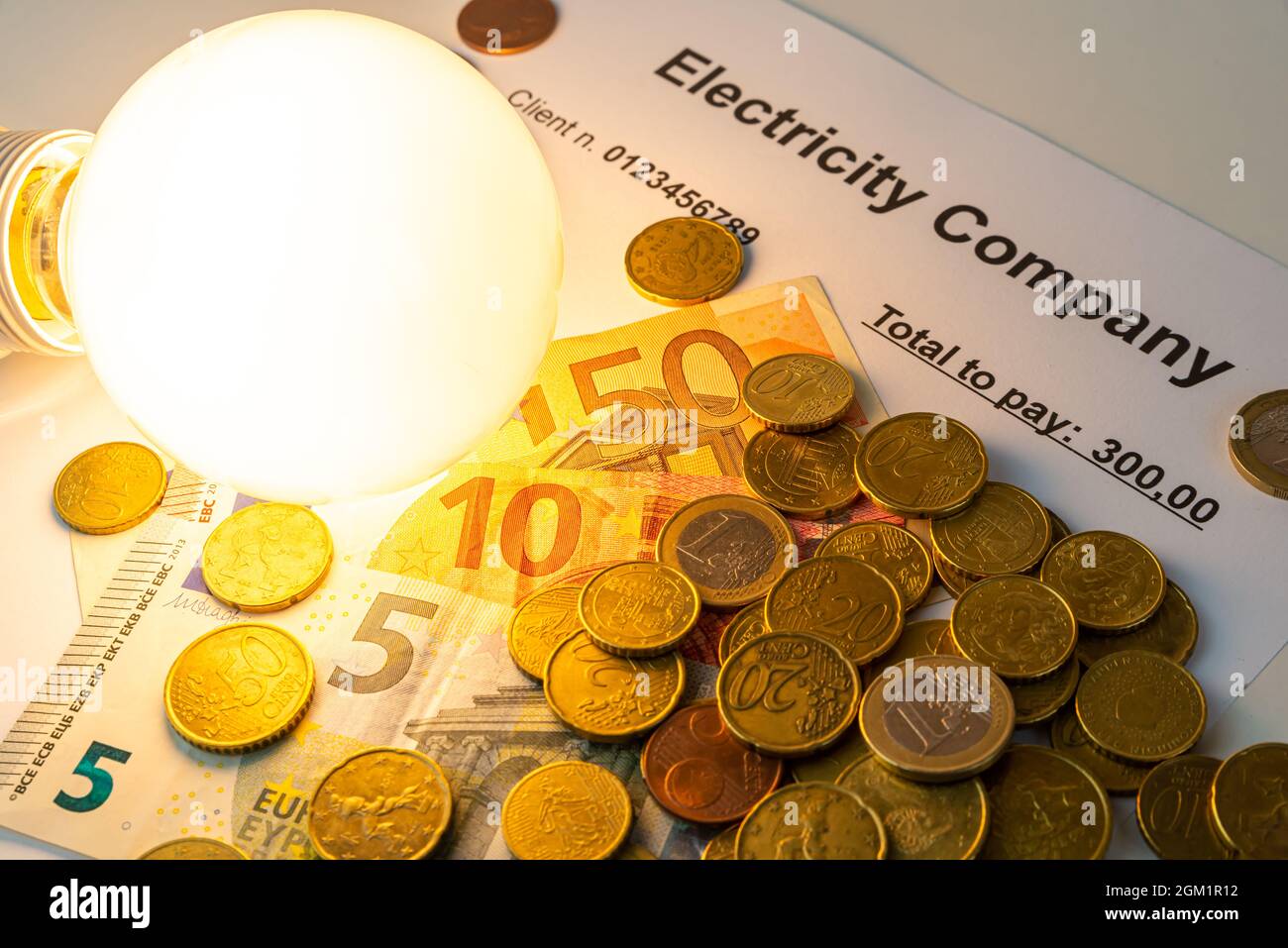 Light bulb on, with banknotes, coins and energy bill. Increase in