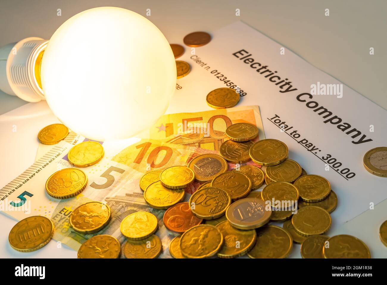 Light bulb on, with banknotes, coins and energy bill. Increase in