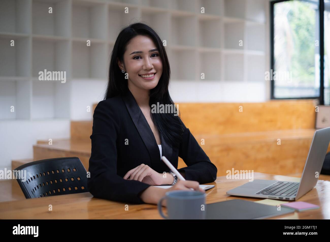 Young undergraduate student studying online class by laptop computer