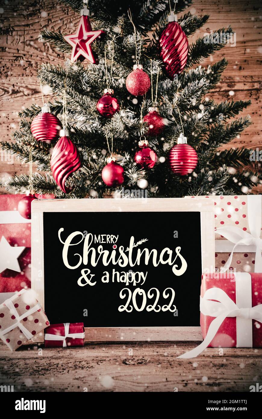 Calligraphy Merry Christmas 2022 English Calligraphy Merry Christmas And A Happy 2022. Christmas Tree With  Gifts, Red Ball Ornament And Sowflakes Stock Photo - Alamy