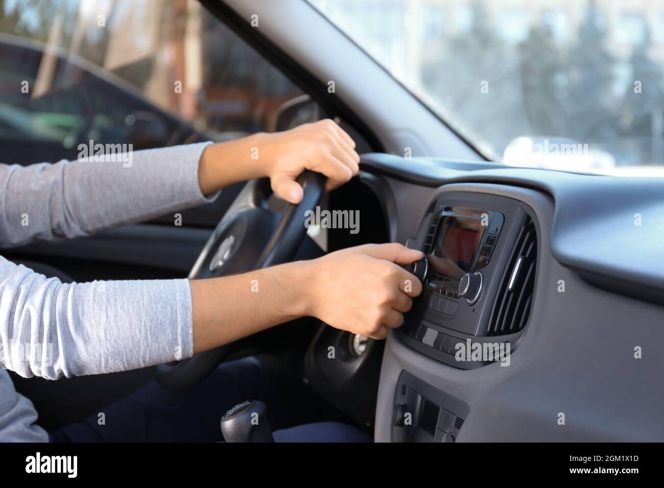 Man tuning radio in car Stock Photo Alamy
