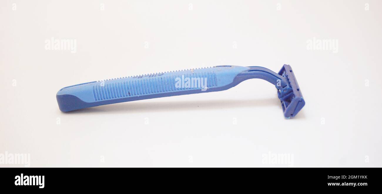 Moustache and beard shaver with used razor blade on an isolated white