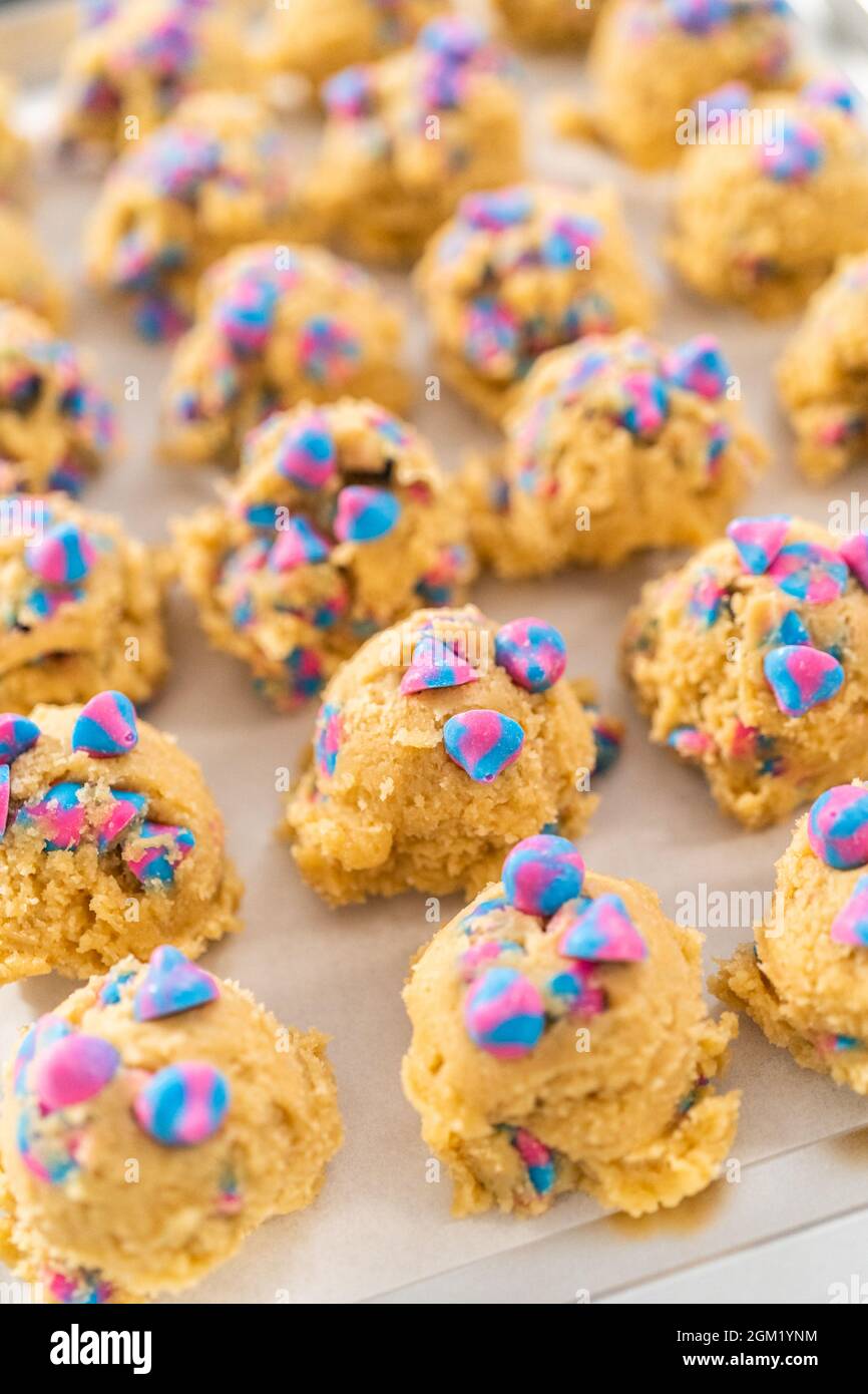 Chilled cookie dough scoops on the baking sheet to bake unicorn