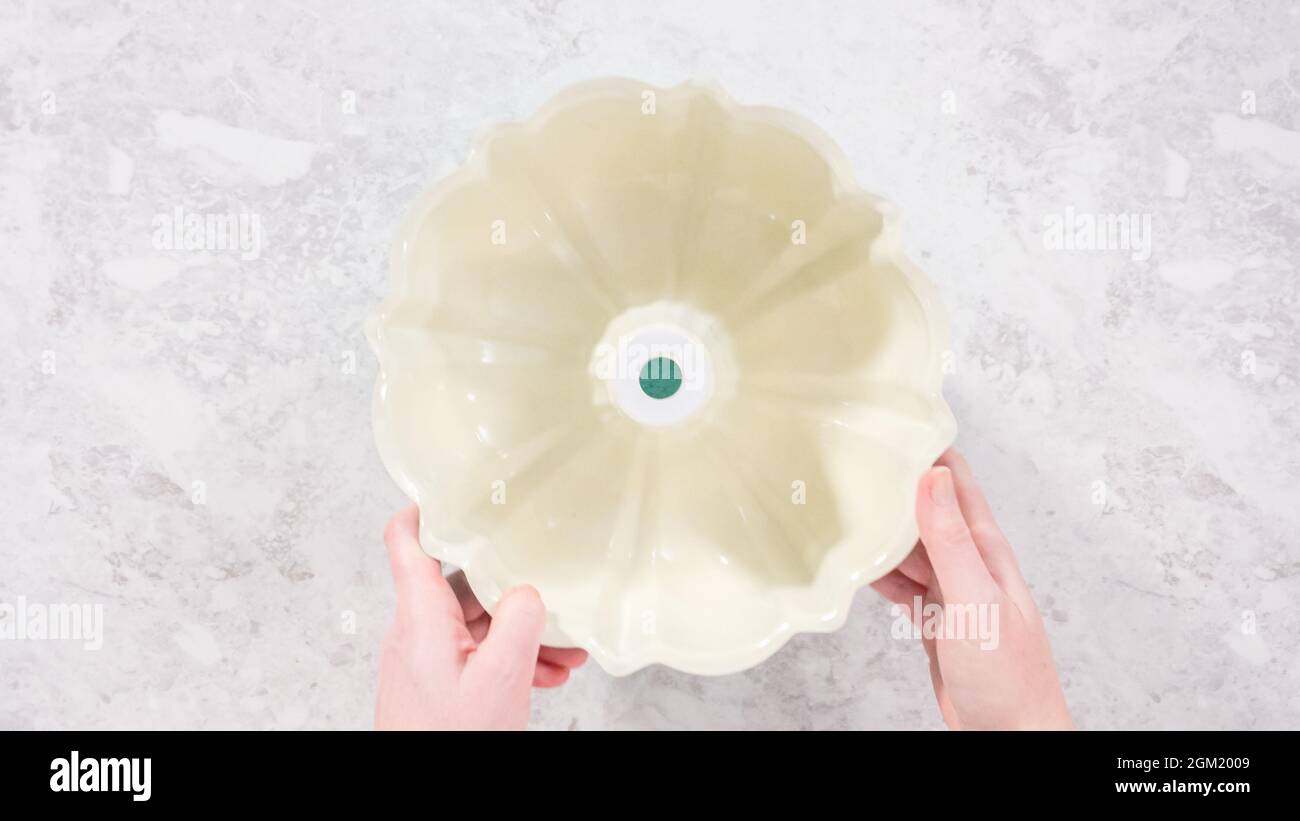 Flat lay. Step by step. Greasing bundt cake pan with vegetable ...