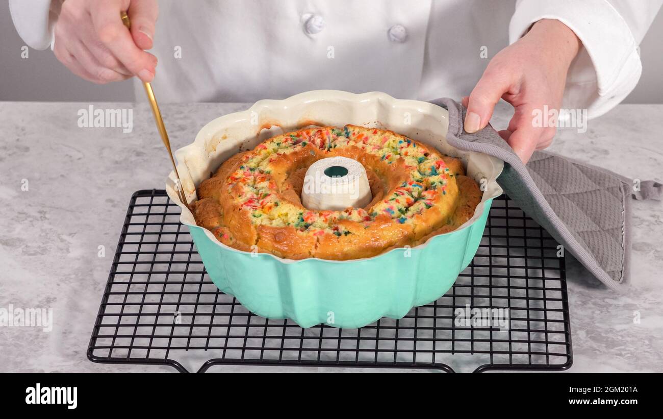 Step by step. Removing freshly baked funfettti bundt cake from the