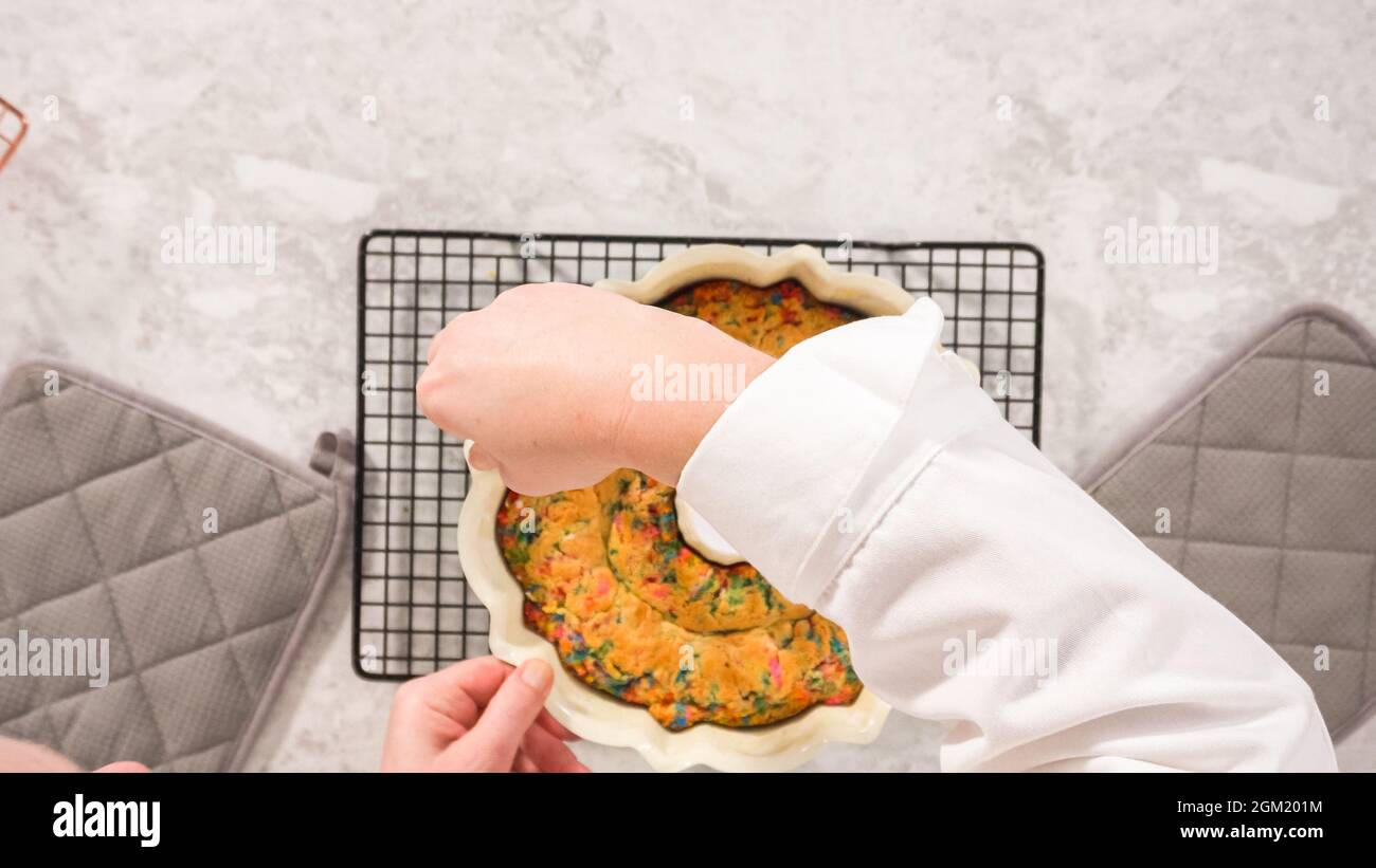 Flat lay. Step by step. Removing freshly baked funfettti bundt cake