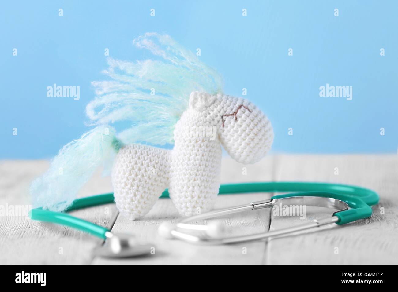 Toy horse and stethoscope on table. Pediatrician concept Stock Photo