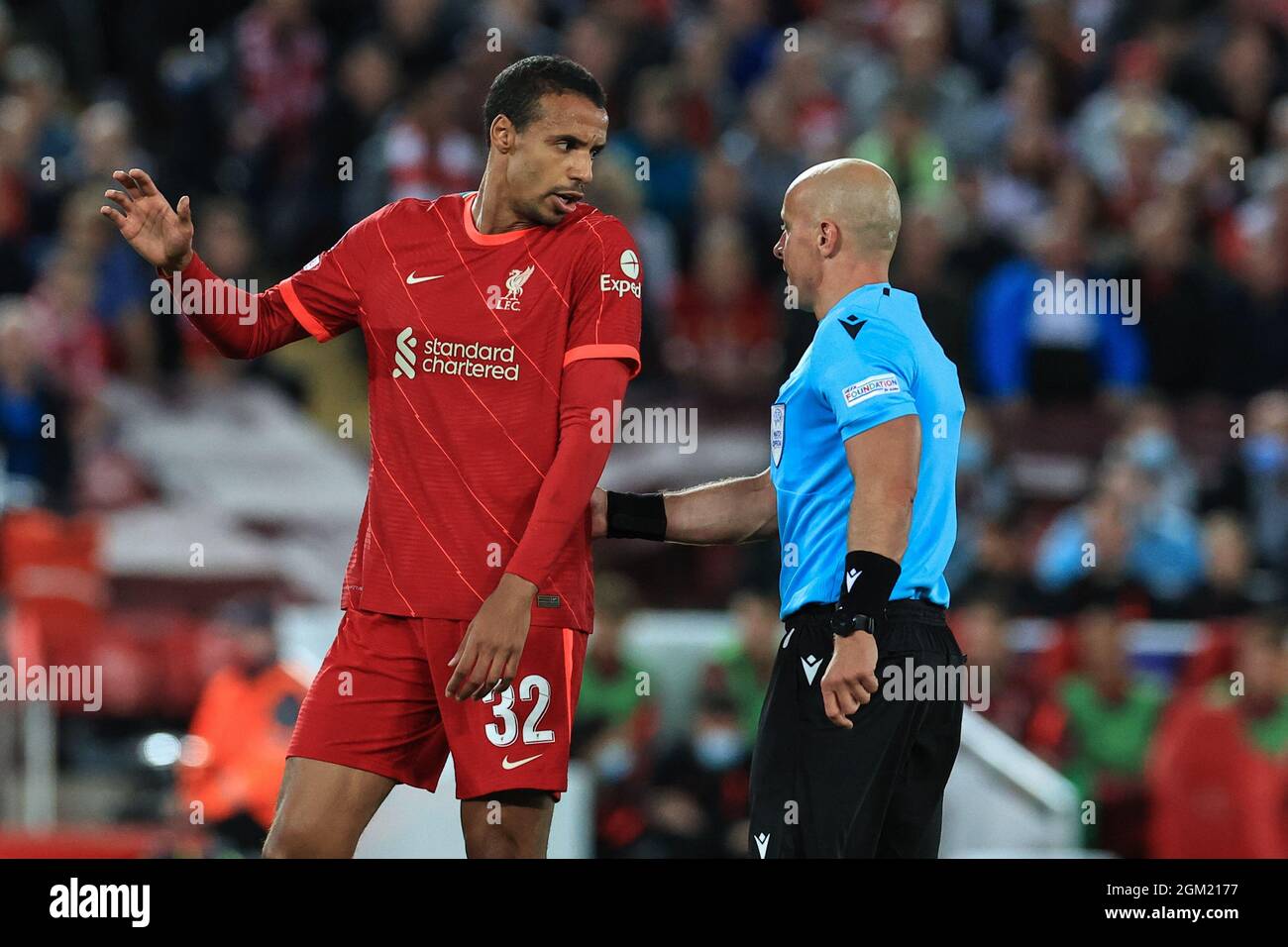 Joel Matip #32 of Liverpool speaks to referee Szymon Marciniak Stock Photo