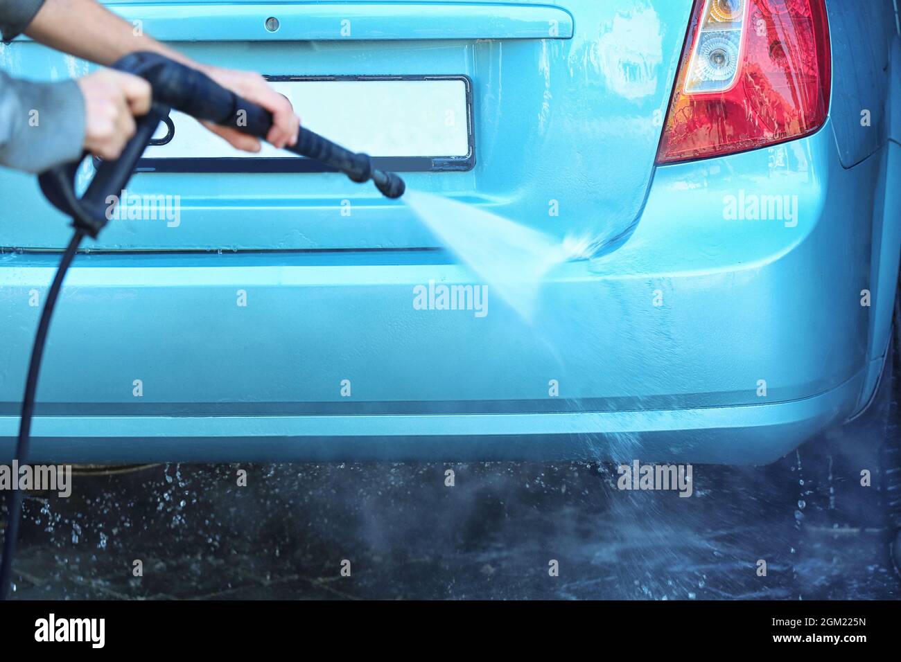 Man cleaning automobile with high pressure water at car wash Stock Photo Alamy