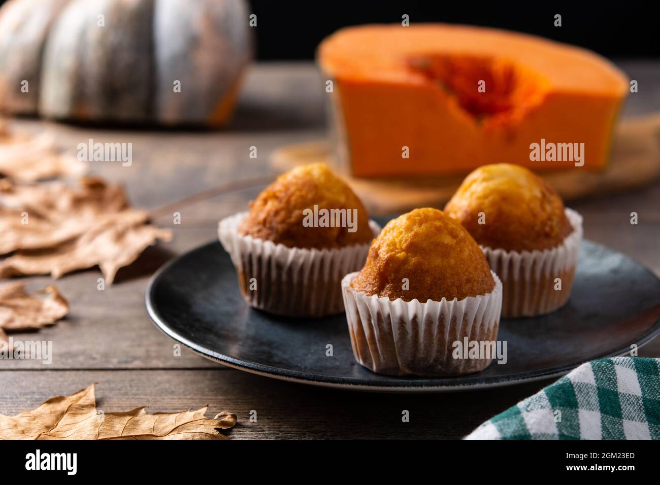 Pumpkin muffins on wooden table Stock Photo