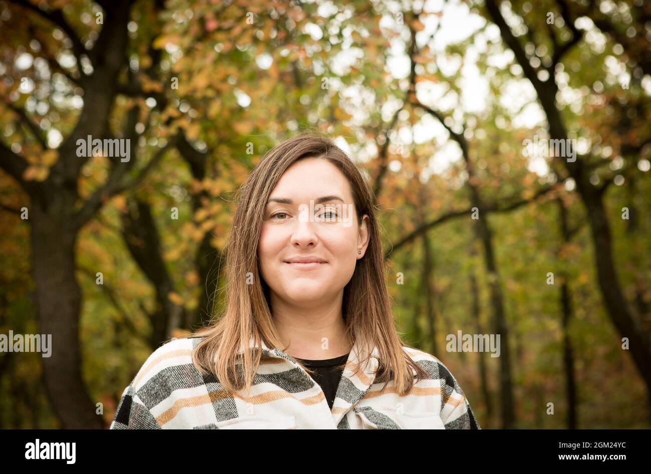 Fall. Portrait of a young beautiful woman in a yellow autumn forest ...