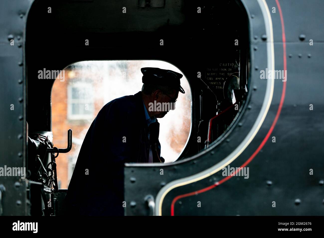 Kidderminster, Worcs, UK. 16th Sep, 2021. A driver is silhouetted in his cab as he prepares his engine for a day's travel on the opening day of the Severn Valley Railway's Autumn Steam Gala, Kidderminster, Worcestershire. The gala lasts until Sunday 19th September and features guest locos. Credit: Peter Lopeman/Alamy Live News Stock Photo