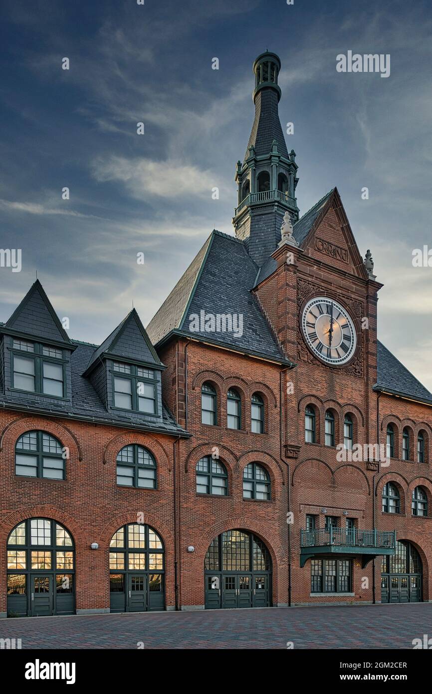 CRRofNJ Terminal - View to the red brick facade, steeple and outdoor clock. The terminal is also known as the Communipaw Terminal in Liberty State Par Stock Photo