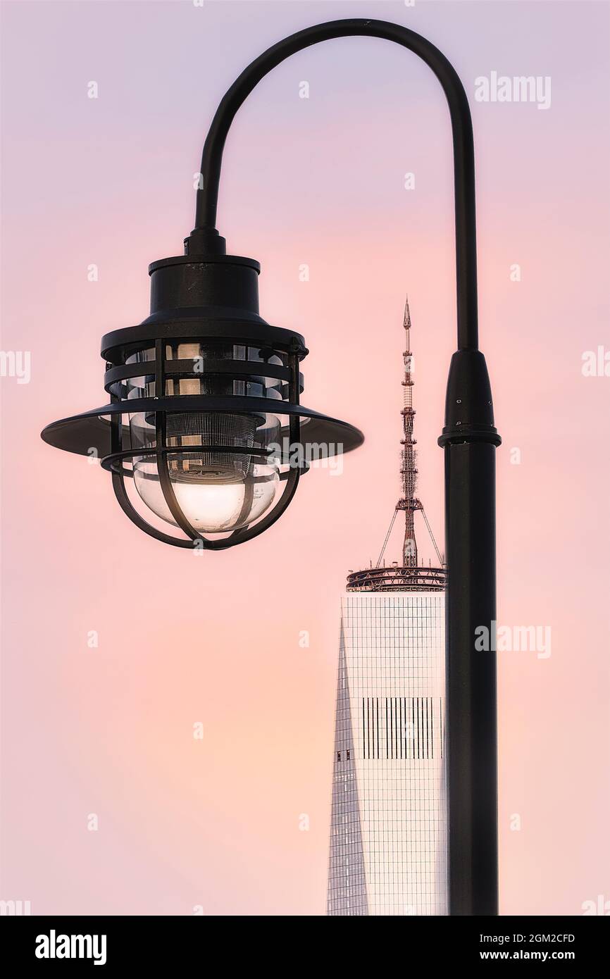 Framing The World Trade Center - Street lamp frames the WTC during sunset. One World Trade Center is comonly know as the Freedom Tower.   This image i Stock Photo