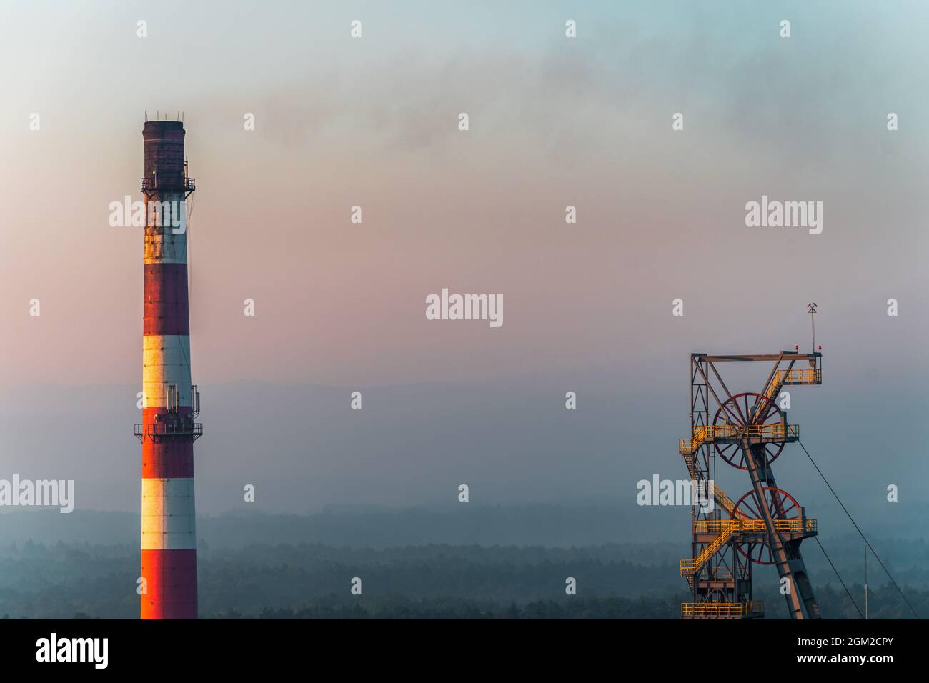 mine chimney and mine shaft against the background of forests Stock