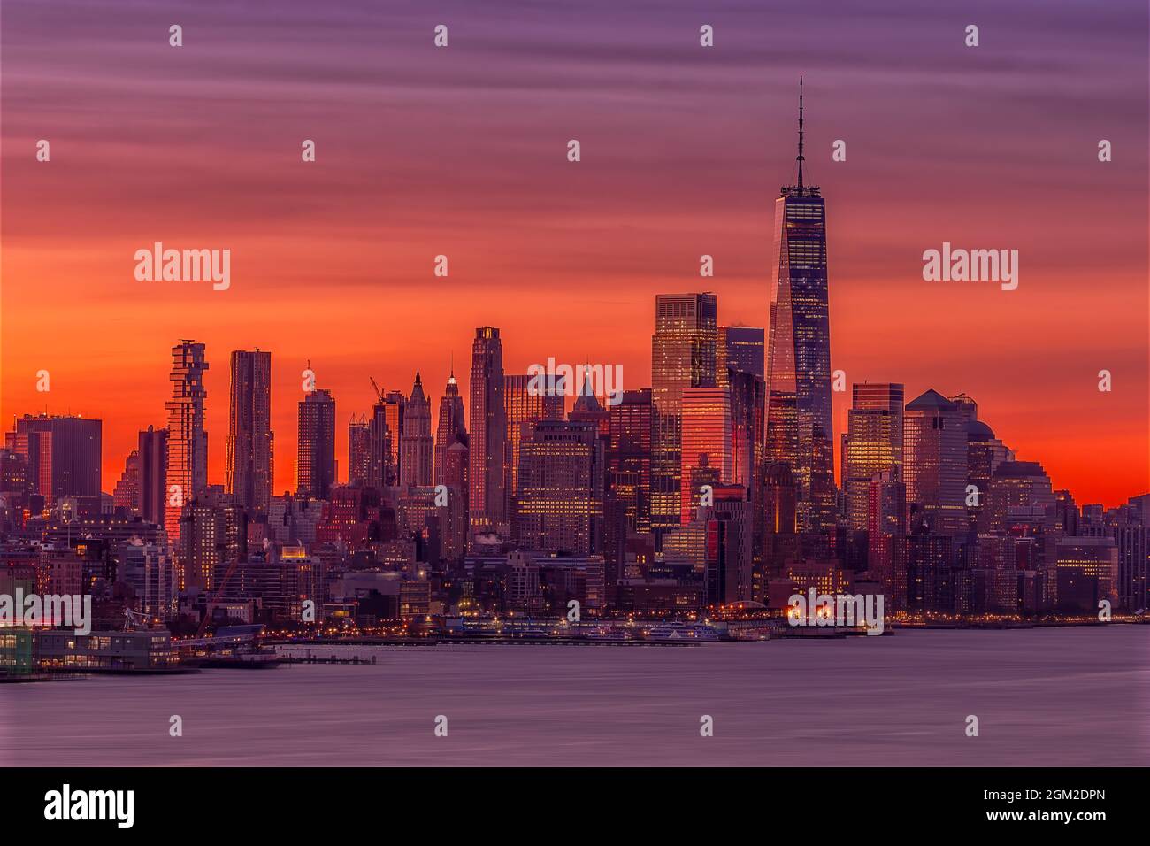 Manhattan NYC Awakens - The commonly referred to as the Freedom Tower at One World Trade Center along with the Financial District wake up to a spectac Stock Photo